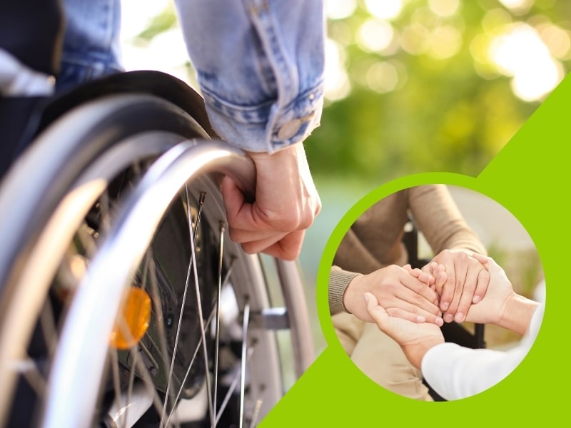 Close-up of hands on a wheelchair wheel, symbolising care and assistance for people with disabilities.