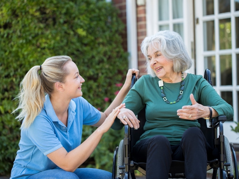 Two women smiling together, representing the positive impact of supported tenancy services in the community.