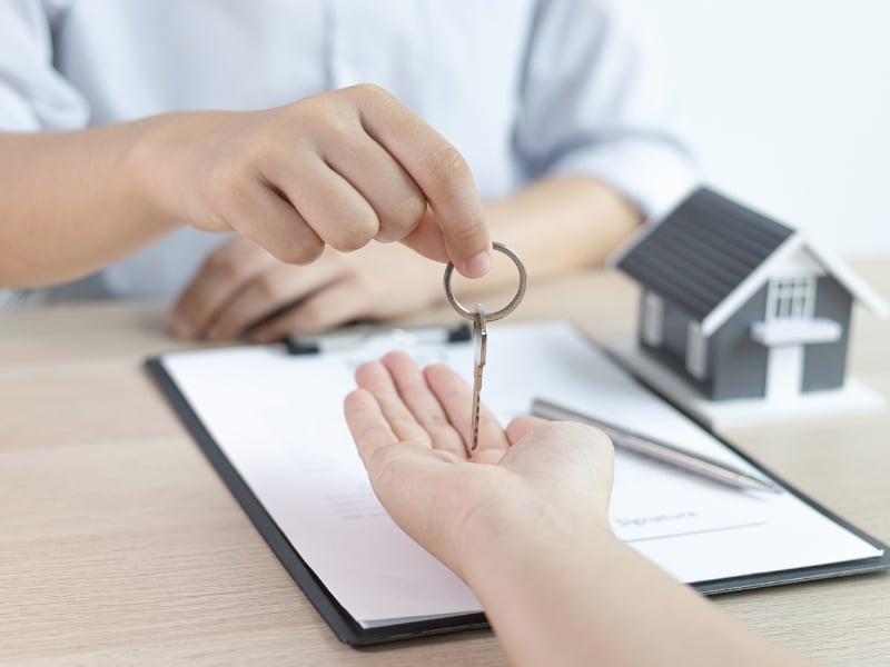 Person receiving house keys after being approved to apply for tenancy assistance successfully.